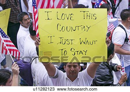 Man holds sign saying "I love this country" along with hundreds of thousands of immigrants participating in march for Immigrants and Mexicans protesting against Illegal Immigration reform by U. S. Congress, Los Angeles, CA, May 1, 2006 View Large Photo Image Stock Image - Man holds sign saying "I love this country" along with hundreds of thousands of immigrants participating in march for Immigrants and Mexicans protesting against Illegal Immigration reform by U. S. Congress, Los Angeles, CA, May 1, 2006. Fotosearch