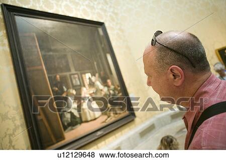 Stock Photo - Man looks at Las Meninas by Velazquez as shown in the Museum de Prado, Prado Museum, Madrid, Spain. Fotosearch