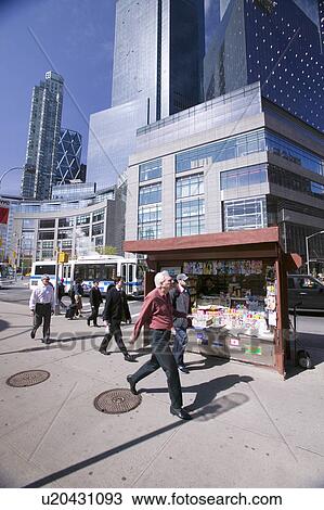 Man walks by magazine stand near Columbus Circle in Manhattan, New York City, New York View Large Photo Image Stock Image - Man walks by magazine stand near Columbus Circle in Manhattan, New York City, New York. Fotosearch