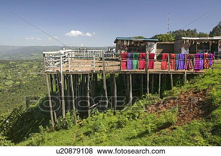 Stock Photo - Masai blankets hang on deck overlooking Great Rift Valley in springtime, Kenya, Africa. Fotosearch