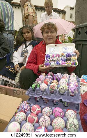 Stock Image - Mexican-American woman shows rainbow colored eggs at annual Old Spanish Days Fiesta held every August in Santa Barbara, California. Fotosearch