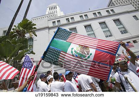 Mexican flag is superimposed over American flag in front of City Hall, Los Angeles, while hundreds of thousands of immigrants participate in march for Immigrants and Mexicans protesting against Illegal Immigration reform by U. S. Congress, Los Angeles, CA, View Large Photo Image Stock Image - Mexican flag is superimposed over American flag in front of City Hall, Los Angeles, while hundreds of thousands of immigrants participate in march for Immigrants and Mexicans protesting against Illegal Immigration reform by U. S. Congress, Los Angeles, CA,. Fotosearch