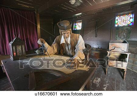 Stock Image - Model of Christopher Columbus at desk with map in his cabin at Muelle de las Carabelas, Palos de la Frontera - La Rábida, the Huelva Provence of Andalucia and Southern Spain, the site where Columbus departed from the Old World to the New World in August 3. Fotosearch