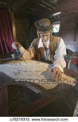 Stock Photography - Model of Christopher Columbus at desk with map in his cabin at Muelle de las Carabelas, Palos de la Frontera - La Rábida, the Huelva Provence of Andalucia and Southern Spain, the site where Columbus departed from the Old World to the New World in August 3. Fotosearch