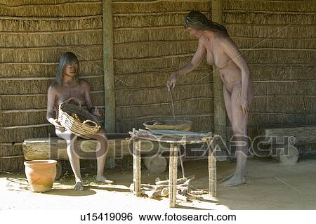 Stock Photograph - Models of Native Americans encountered by Christopher Columbus on display at Muelle de las Carabelas, Palos de la Frontera - La Rábida, the Huelva Provence of Andalucia and Southern Spain, the site where Columbus departed from the Old World to the New Wor. Fotosearch