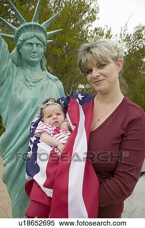 Mother and newborn baby (Sophia Larson) wrapped in American flag stand in front of a Statue of Liberty, was born on October 16th, the birthday of the 300 Millionth American, Ventura, California View Large Photo Image Stock Photography - Mother and newborn baby (Sophia Larson) wrapped in American flag stand in front of a Statue of Liberty, was born on October 16th, the birthday of the 300 Millionth American, Ventura, California. Fotosearch