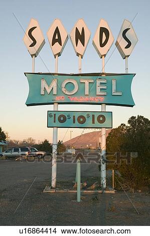 Picture - Neon lights come on at sunset at Sands Motel with RV Parking for $10, located at the intersection of Route 54 & 380 in Carrizozo, New Mexico. Fotosearch