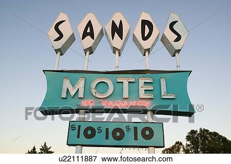 Stock Photo - Neon lights come on at sunset at Sands Motel with RV Parking for $10, located at the intersection of Route 54 & 380 in Carrizozo, New Mexico. Fotosearch
