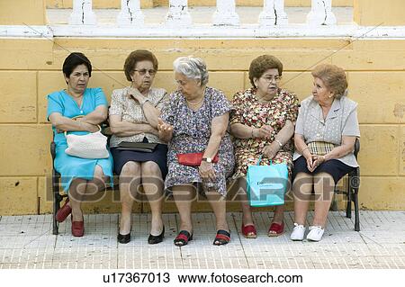 Older women sit on bench in village of Southern Spain off highway A49 west of Sevilla View Large Photo Image Stock Image - Older women sit on bench in village of Southern Spain off highway A49 west of Sevilla. Fotosearch