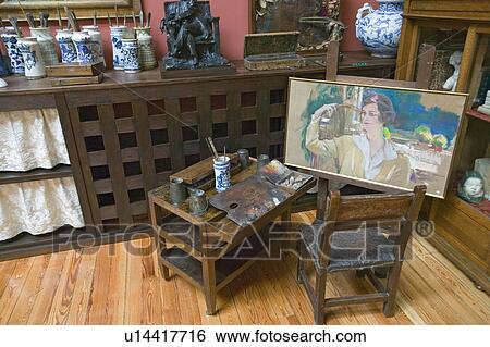 Stock Photograph - Paintings with easel in foreground by Joaquín Sorolla y Bastida (1863-1923) as seen in The Sorolla Museum, Madrid, Spain. Fotosearch