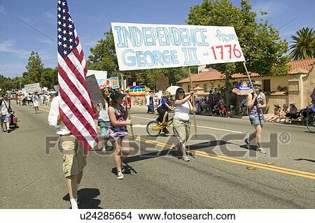 Parade participants carrying banner protesting George W. Bush make their way down main street during a Fourth of July parade in Ojai, CA View Large Photo Image Picture - Parade participants carrying banner protesting George W. Bush make their way down main street during a Fourth of July parade in Ojai, CA. Fotosearch