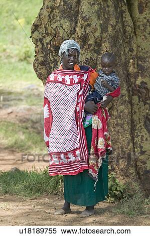Portrait of Masai Mother and Baby in traditional red toga at Lewa Wildlife Conservancy in North Kenya, Africa View Large Photo Image Stock Photography - Portrait of Masai Mother and Baby in traditional red toga at Lewa Wildlife Conservancy in North Kenya, Africa. Fotosearch