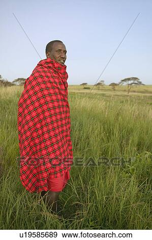 Stock Photo - Portrait of Masai Warrior in traditional red toga at Lewa Wildlife Conservancy in North Kenya, Africa. Fotosearch