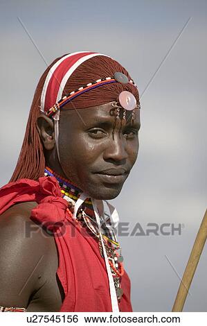 Portrait of Masai Warrior in traditional red toga at Lewa Wildlife Conservancy in North Kenya, Africa View Large Photo Image Stock Photograph - Portrait of Masai Warrior in traditional red toga at Lewa Wildlife Conservancy in North Kenya, Africa. Fotosearch