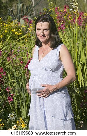 Pregnant 40 year old mother to-be poses in gardens in springtime in Ojai, California View Large Photo Image Stock Photo - Pregnant 40 year old mother to-be poses in gardens in springtime in Ojai, California. Fotosearch