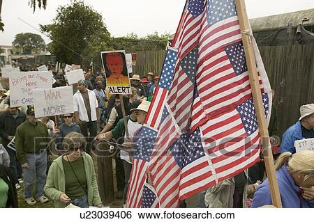 Stock Photograph - Protesters march with US Flag against President George W. Bush and the Iraq war at an anti-Iraq War protest march in Santa Barbara, California on March 17, 2007. Fotosearch