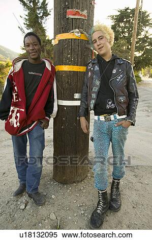 Stock Photography - Punk teenagers, one with blond and blue hair, the other an African American, in Frazier Park, California. Fotosearch