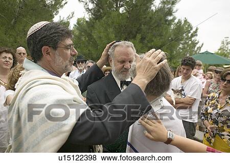 Stock Photo - Rabbi blesses the bride and groom at a traditional Jewish wedding in Ojai, CA. Fotosearch