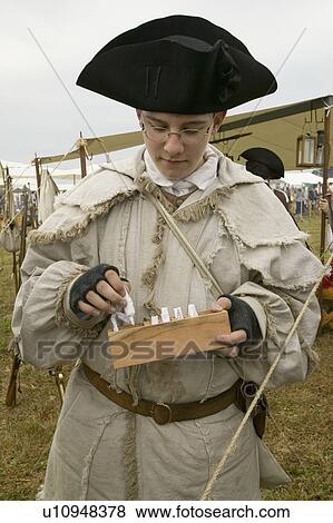 Stock Photo - Re-enactment of Revolutionary War Encampment demonstrates camp life of Continental Army as part of the 225th Anniversary of the Siege of Yorktown, Virginia, 1781, ending the American Revolution with the defeat of the British Army and Lord Cornwallis surre. Fotosearch