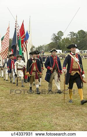 Stock Image - Regimental flag procession at the 225th Anniversary of the Victory at Yorktown, a reenactment of the siege of Yorktown, where General George Washington commanded 17, 600 American troops and French Comte de Rochambeau lead 5500 French troops, together defea. Fotosearch
