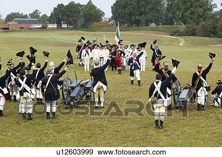 Stock Photo - Revolutionary War re-enactors re-create the cannon fire and subsequent cease-fire of the British army, in which they flew the white flag requesting a truce, bringing an end to the bombardment by the Allied armies and beginning the negotiations to surrende. Fotosearch