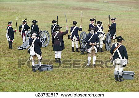 Stock Photo - Revolutionary War re-enactors re-create the cannon fire and subsequent cease-fire of the British army, in which they flew the white flag requesting a truce, bringing an end to the bombardment by the Allied armies and beginning the negotiations to surrende. Fotosearch