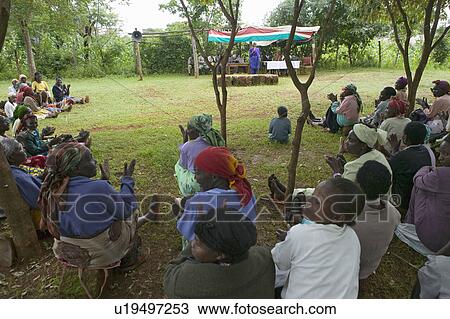 Stock Image - Sarah Kilemi, wife of Parliament member Kilemi Mwiria, speaks to "Women without Husbands" women who have been ostracized from society or who have lost their husbands and only have themselves as a group to look after each other in Meru, Kenya, Africa. Fotosearch