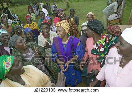 Stock Image - Sarah Kilemi, wife of Parliament member Kilemi Mwiria, speaks to "Women without Husbands" women who have been ostracized from society or who have lost their husbands and only have themselves as a group to look after each other in Meru, Kenya, Africa. Fotosearch