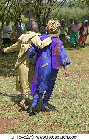 Stock Photo - Sarah Kilemi, wife of Parliament member Kilemi Mwiria, speaks to "Women without Husbands" women who have been ostracized from society or who have lost their husbands and only have themselves as a group to look after each other in Meru, Kenya, Africa. Fotosearch