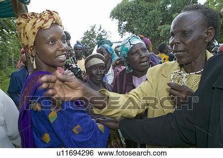 Stock Photograph - Sarah Kilemi, wife of Parliament member Kilemi Mwiria, speaks to "Women without Husbands" women who have been ostracized from society or who have lost their husbands and only have themselves as a group to look after each other in Meru, Kenya, Africa. Fotosearch