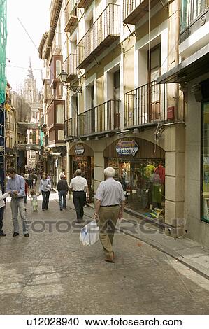 Stock Image - Shoppers in streets of historic Toledo, Spain. Fotosearch