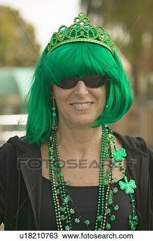 Stock Image - St. Patty's Day, a woman smiles dressed in green for St. Patrick's Day in Santa Barbara, California. Fotosearch