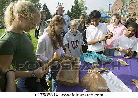 Picture - Students view Indian tools during "Earth Force" Earth Day event in Alexandria, Virginia on Potomac River. Fotosearch