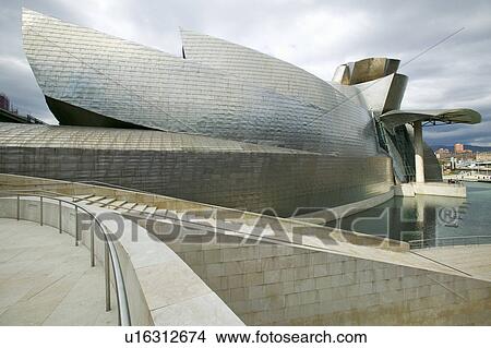 The Guggenheim Museum of Contemporary Art of Bilbao (Bilbo), located on the North Coast of Spain in the Basque region. Nicknamed "The Hole", this is a contemporary museum built of titanium, limestone and glass and was designed by Canadian citizen, Frank O View Large Photo Image Picture - The Guggenheim Museum of Contemporary Art of Bilbao (Bilbo), located on the North Coast of Spain in the Basque region. Nicknamed "The Hole", this is a contemporary museum built of titanium, limestone and glass and was designed by Canadian citizen, Frank O. Fotosearch