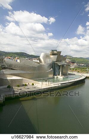 The Guggenheim Museum of Contemporary Art of Bilbao (Bilbo) on the river Ibaizabal, located on the North Coast of Spain in the Basque region. Nicknamed "The Hole", this is a contemporary museum built of titanium, limestone and glass and was designed by Ca View Large Photo Image Picture - The Guggenheim Museum of Contemporary Art of Bilbao (Bilbo) on the river Ibaizabal, located on the North Coast of Spain in the Basque region. Nicknamed "The Hole", this is a contemporary museum built of titanium, limestone and glass and was designed by Ca. Fotosearch