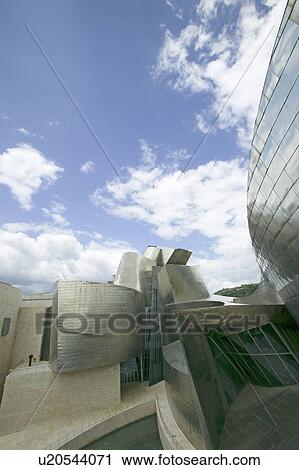 The Guggenheim Museum of Contemporary Art of Bilbao (Bilbo), located on the North Coast of Spain in the Basque region. Nicknamed "The Hole", this is a contemporary museum built of titanium, limestone and glass and was designed by Canadian citizen, Frank O View Large Photo Image Stock Image - The Guggenheim Museum of Contemporary Art of Bilbao (Bilbo), located on the North Coast of Spain in the Basque region. Nicknamed "The Hole", this is a contemporary museum built of titanium, limestone and glass and was designed by Canadian citizen, Frank O. Fotosearch