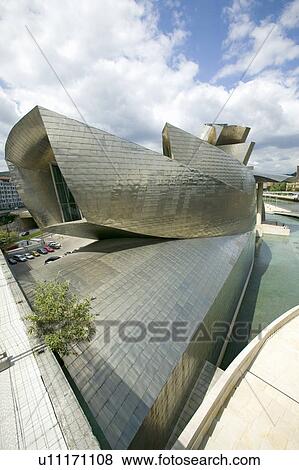 The Guggenheim Museum of Contemporary Art of Bilbao (Bilbo), located on the North Coast of Spain in the Basque region. Nicknamed "The Hole", this is a contemporary museum built of titanium, limestone and glass and was designed by Canadian citizen, Frank O View Large Photo Image Stock Photo - The Guggenheim Museum of Contemporary Art of Bilbao (Bilbo), located on the North Coast of Spain in the Basque region. Nicknamed "The Hole", this is a contemporary museum built of titanium, limestone and glass and was designed by Canadian citizen, Frank O. Fotosearch