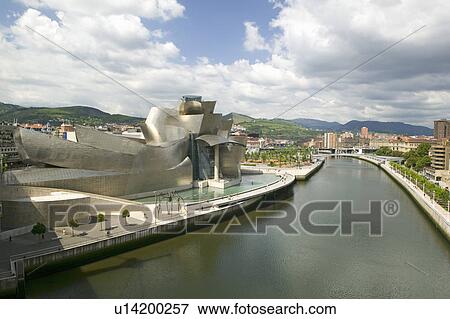 The Guggenheim Museum of Contemporary Art of Bilbao (Bilbo) on the river Ibaizabal, located on the North Coast of Spain in the Basque region. Nicknamed "The Hole", this is a contemporary museum built of titanium, limestone and glass and was designed by Ca View Large Photo Image Stock Photo - The Guggenheim Museum of Contemporary Art of Bilbao (Bilbo) on the river Ibaizabal, located on the North Coast of Spain in the Basque region. Nicknamed "The Hole", this is a contemporary museum built of titanium, limestone and glass and was designed by Ca. Fotosearch