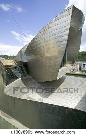 Stock Photography - The Guggenheim Museum of Contemporary Art of Bilbao (Bilbo), located on the North Coast of Spain in the Basque region. Nicknamed "The Hole", this is a contemporary museum built of titanium, limestone and glass and was designed by Canadian citizen, Frank O. Fotosearch
