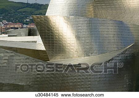 Stock Photography - The Guggenheim Museum of Contemporary Art of Bilbao (Bilbo), located on the North Coast of Spain in the Basque region. Nicknamed "The Hole", this is a contemporary museum built of titanium, limestone and glass and was designed by Canadian citizen, Frank O. Fotosearch