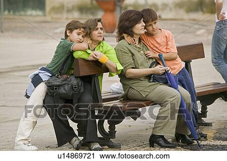 Two mothers and children sit on bench in village center of medieval town of Tomar, Portugal View Large Photo Image Stock Image - Two mothers and children sit on bench in village center of medieval town of Tomar, Portugal. Fotosearch