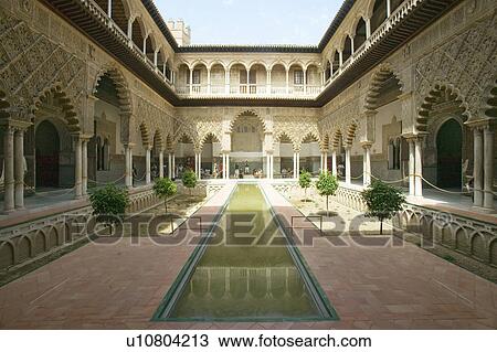 Stock Image - View of the Medieval garden and courtyard, the Patio de las Doncellas, of the Royal Palace, Sevilla, Spain, dating back to the 9th century. Fotosearch
