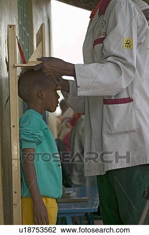 Stock Image - Young boy with HIV/AIDS is measured at the Pepo La Tumaini Jangwani, HIV/AIDS Community Rehabilitation Program, Orphanage & Clinic. Pepo La Tumaini Jangwani (wind of hope in the arid place) offers hope, support and care for orphan and vulnerable children. Fotosearch