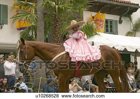 Young girl in pink dress rides horse in annual Old Spanish Days Fiesta held every August in Santa Barbara, California View Large Photo Image Stock Photo - Young girl in pink dress rides horse in annual Old Spanish Days Fiesta held every August in Santa Barbara, California. Fotosearch