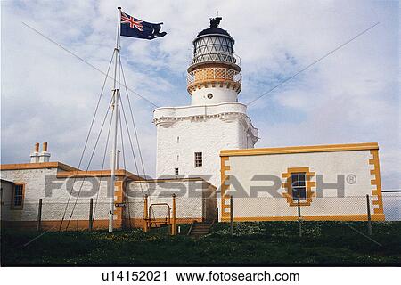 Stock Image - lighthouse located at KinnairdHead, Scotland. Fotosearch