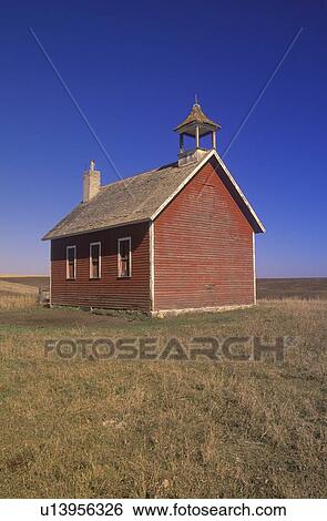 Stock Photograph - Old red schoolhouse on prairie. Fotosearch