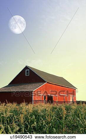 Stock Image - Photo montage: Red barn and corn field under a full moon. Fotosearch