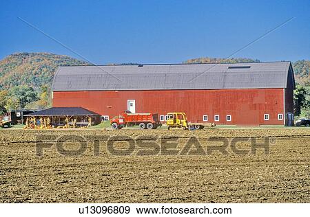 Stock Photo - Red barn and farm along scenic highway. Fotosearch
