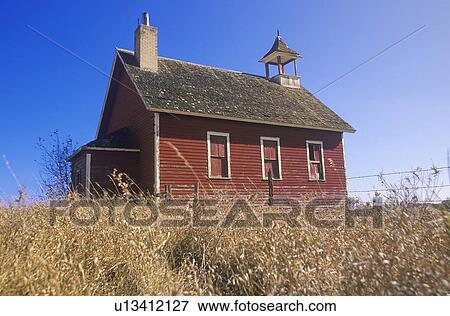 Stock Photo - Red schoolhouse on prairie. Fotosearch
