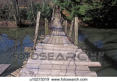 Stock Photo - A walking bridge over a creek. Fotosearch
